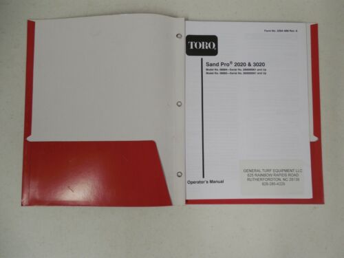 Open booklet and red folder on a white surface.