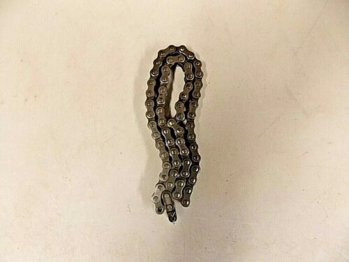 A small, coiled metal chain on a plain surface.