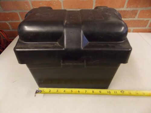 Black plastic container with a tape measure in front of it.