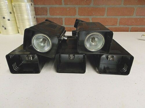 Four black outdoor security cameras with a brick wall background.