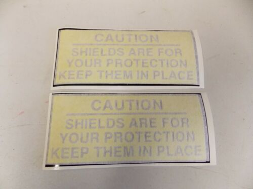 Two caution signs about shields for your protection.