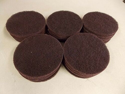 Stacked round brown felt pads on a white surface.