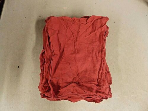 A neatly folded red cloth on a light surface.