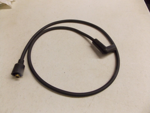 Black cable with connectors on both ends laid on a light surface.
