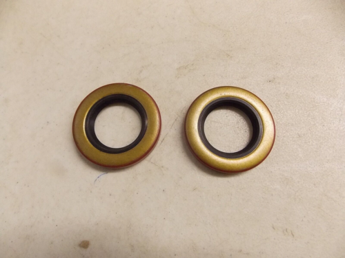 Two small circular metal and rubber washers on a surface.